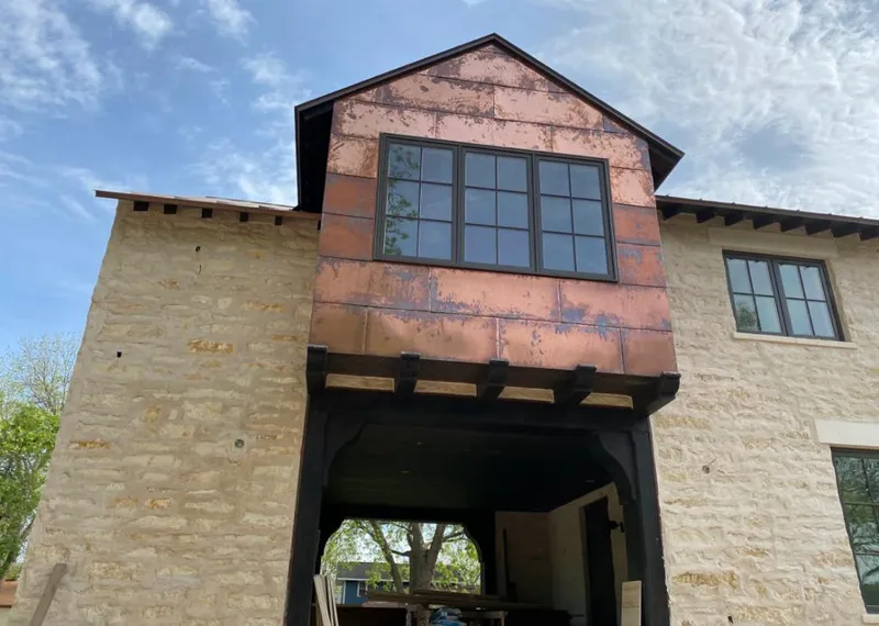 Copper metal panel facade on a stone building for Roof Repair in Brushy Creek